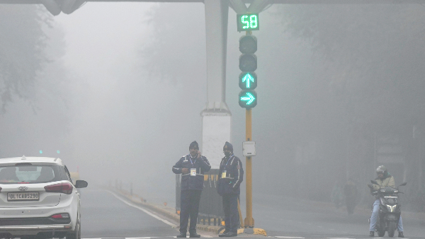 Traffic police personnel during a cold and foggy winter morning, in New Delhi