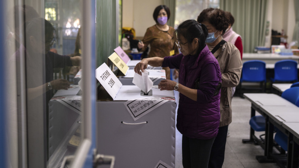 People cast a vote at a polling station during the elections in New Taipei City