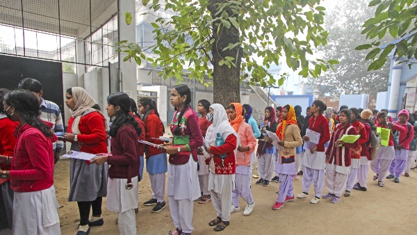 Students line up to enter the examination hall to appear in the class 10th exam