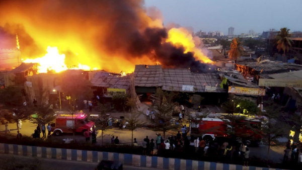 Firefighters at the spot after a fire broke out in a slum, at Bhayandar in Thane district