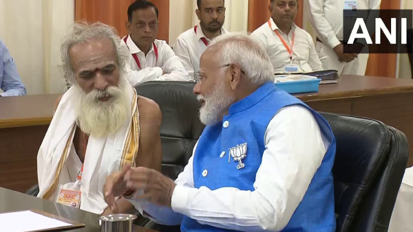 Who Is The Sadhu Sitting Next To PM Modi
