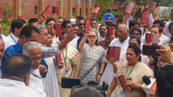 Congress leader Sonia Gandhi and other INDIA bloc leaders show copies of the Constitution of India at the Parliament House complex on the first day of the first session of the 18th Lok Sabha