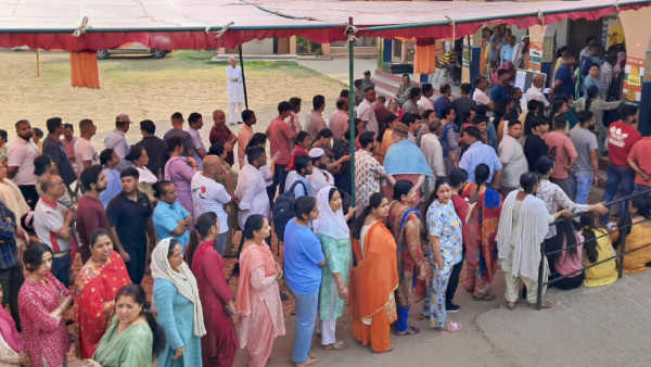 People wait in a queue to cast their votes at a polling booth during the seventh and last phase of Lok Sabha elections in Paonta Sahib Sirmour Himachal Pradesh