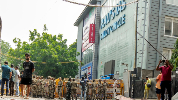 Security personnel stand guard near a UPSC exam coaching centre after three civil services aspirants died when the basement of the coaching centre was flooded by rainwater in New Delhi Sunday July 28 2024