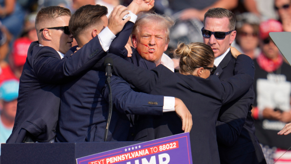 Republican presidential candidate former President Donald Trump is helped off the stage at a campaign event in Butler Pa on Saturday July 13 2024