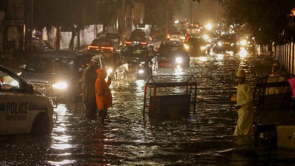 Vehicles move through a waterlogged road during rain in Hyderabad Sunday July 14 2024