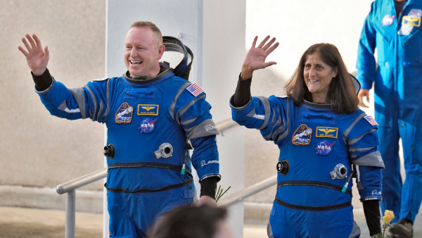 NASA astronauts Butch Wilmore left and Suni Williams wave as they leave the operations and checkout building for a trip to launch pad at Space Launch Complex 41 Wednesday June 5 2024 in Cape Canaveral