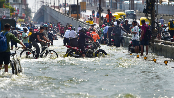 Motorists and pedestrians wade through the flooded Outer Ring Road near Bellandur following heavy monsoon rains in Bengaluru Tuesday Aug 30 2022
