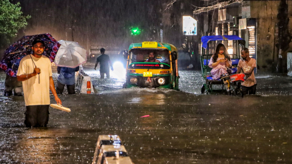People wade through a waterlogged road during rain at Jangpura area in New Delhi Wednesday July 31 2024 People wade through a waterlogged road during rain at Jangpura area in New Delhi Wednesday July 31 2024
