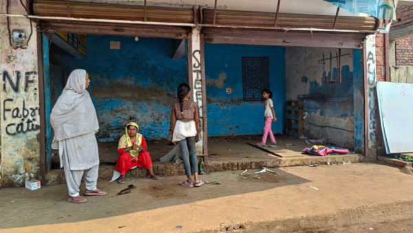Locals outside an empty shop after public works department PWD pasted notices on the properties of several people asking them to remove any illegal construction and warning of action in violence-hit Maharajganj area of Bahraich UP Saturday Oct 19 2024