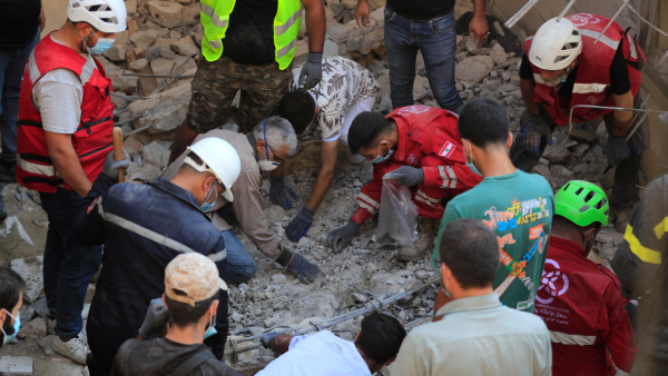 Rescue workers dig as they search for victims on a hotel-turned-shelter for displaced people hit by an Israeli airstrike in Wardaniyeh south Lebanon Wednesday Oct 9 2024