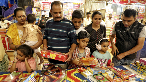 People purchase firecrackers from a shop ahead of Diwali festival in Bengaluru Tuesday Oct 29 2024