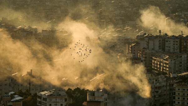 A flock of birds fly as smoke rises from the site of an Israeli airstrike in Dahiyeh in the southern suburb of Beirut Lebanon Thursday Oct 24 2024