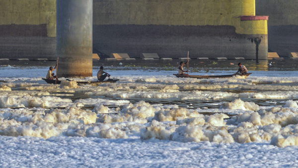 Toxic foam floats on the surface of the polluted Yamuna river
