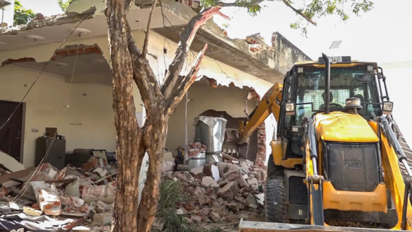 A bulldozer being used to demolish the illegal construction belonging to Naseeb Choudhary who is accused of knife attack on RSS members in Jaipur Sunday Oct 20 2024