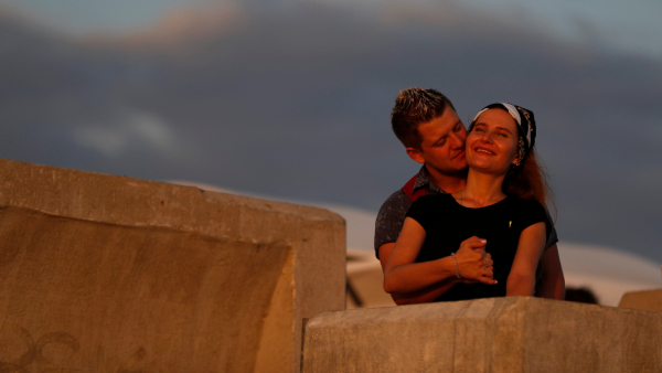 A couple embraces as they stand on the Black Sea waterfront during the 2018 soccer World Cup in Sochi Russia
