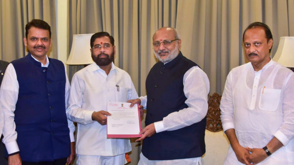 Maharashtra Governor C P Radhakrishnan receives Shiv Sena leader Eknath Shinde s resignation as state chief minister as BJP leader Devendra Fadnavis and NCP leader Ajit Pawar look on in Mumbai Tuesday Nov 26 2024 The governor asked Shinde to act as a caretaker chief minister till a new CM is sworn in