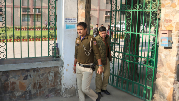 Police personnel exit from Cambridge School at Shri Niwas Puri during investigation after it received bomb threat over email in New Delhi Friday Dec 13 2024