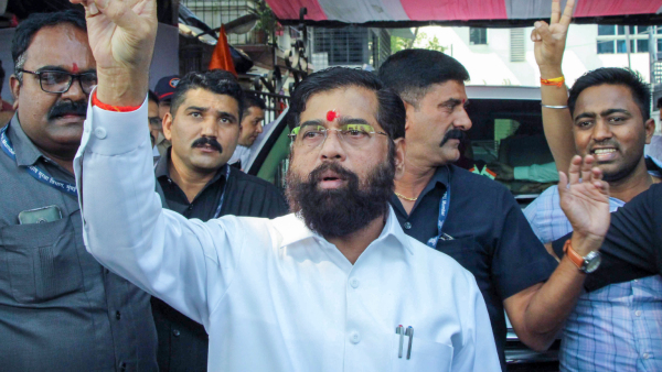 Eknath Shinde flashes victory sign along with supporters