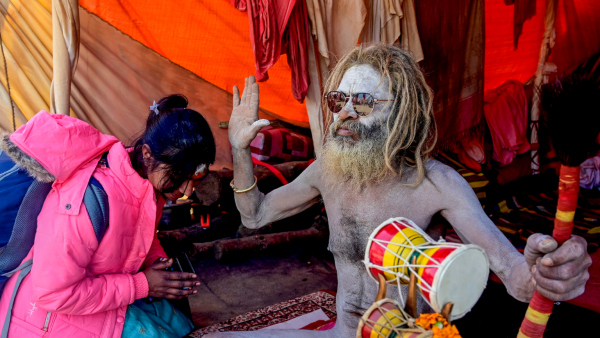 A devotee seeks blessings of a Naga Sadhu during the Maha Kumbh Mela 2025 in Prayagraj Uttar Pradesh Tuesday Jan 21 2025