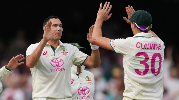 Australia s captain Pat Cummins right and Scot Boland celebrate the wicket of India s Nitish Kumar Reddy during play on the second day of the fifth cricket test between India and Australia at the Sydney Cricket Ground in Sydney Australia Saturday Jan 4 2025