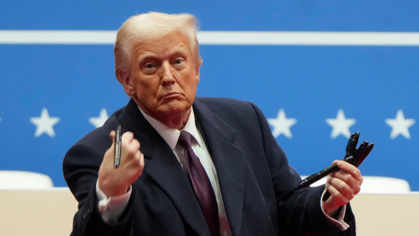 President Donald Trump throws pens used to sign executive orders to the crowd during an indoor Presidential Inauguration parade event in Washington Monday Jan 20 2025