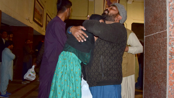 Passengers rescued by security forces from a passenger train attacked by insurgents comfort each other upon their arrival at a railway station in Quetta Pakistan Wednesday March 12 2025