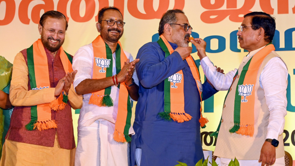 Union Minister of Consumer Affairs Pralhad Joshi offers sweets to the newly-elected Kerala BJP President Rajeev Chandrasekhar as outgoing president K Surendran and party s senor leader Prakash Javadekar look on during a reception in Thiruvananthapuram Monday March 24 2025 Union Minister of Consumer Affairs Pralhad Joshi offers sweets to the newly-elected Kerala BJP President Rajeev Chandrasekhar as outgoing president K Surendran and party s senor leader Prakash Javadekar look on during a reception in Thiruvananthapuram Monday March 24 2025