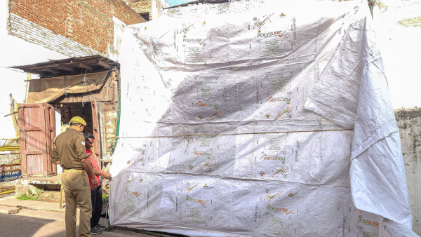 The Shahi Jama Masjid being covered in tarpaulin as prevention against possible holi colour ahead of the celebration in Sambhal Uttar Pradesh Wednesday March 12 2025