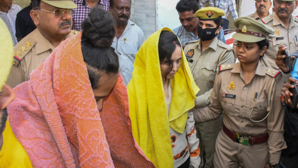 Police take away Merchant Navy officer Saurabh Rajput s wife Muskan and her lover Sahil Shukla after they were arrested in connection with his murder in Meerut Wednesday March 19 2025 Muskan with her partner Sahil allegedly killed her husband Saurabh dismembered his body and sealed the body parts in a drum filled with cement