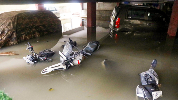 Vehicles partially submerged at the basement of an apartment following heavy rains at Wilson Garden in Bengaluru Monday May 19 2025