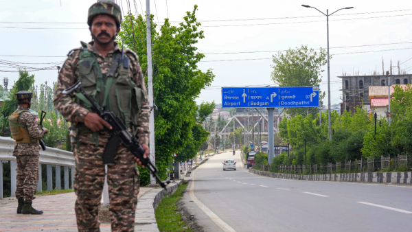 Security personnel stand guard on a road towards the airport in light of the ongoing military conflict between India and Pakistan in Srinagar Jammu and Kashmir Saturday May 10 2025