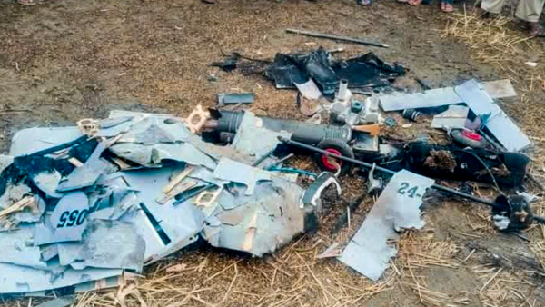 People gather near a suspicious object resembling remains of a drone in light of the ongoing military conflict between India and Pakistan at Indora area of Nurpur in Kangra district Himachal Pradesh Saturday May 10 2025