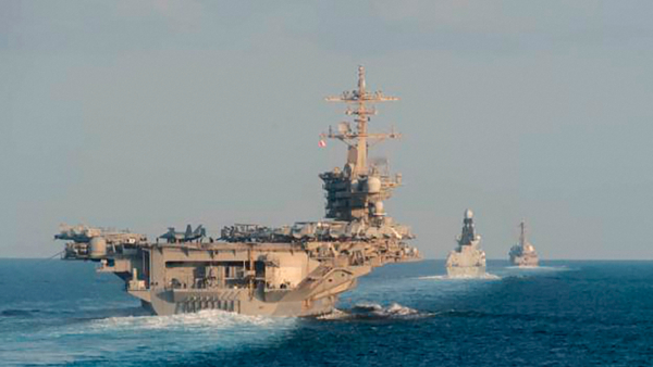 U S Navy the aircraft carrier USS Abraham Lincoln left the air-defense destroyer HMS Defender and the guided-missile destroyer USS Farragut transit the Strait of Hormuz with the guided-missile cruiser USS Leyte Gulf