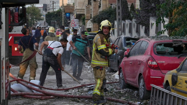Firefighters and people clean up the scene of an explosion at a residence compound after Israeli attacks in Tehran Firefighters and people clean up the scene of an explosion at a residence compound after Israeli attacks in Tehran