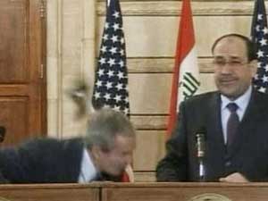 Iraqi journalist throws shoe at George Bush Iraqi journalist throws shoe at George Bush