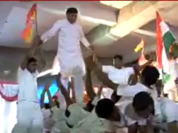 Rajkot BJP candidate Mohan Kundariya walks over school children Rajkot BJP candidate Mohan Kundariya walks over school children