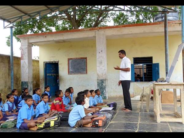 children studying at coconut palm shed at Jittinakatti village