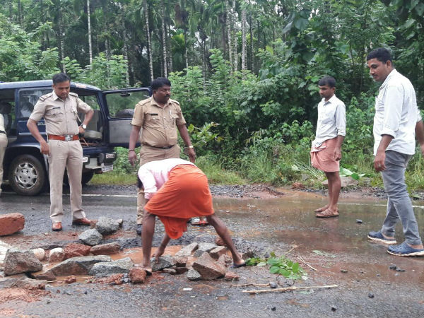 Police officer fills potholes in Sullia 