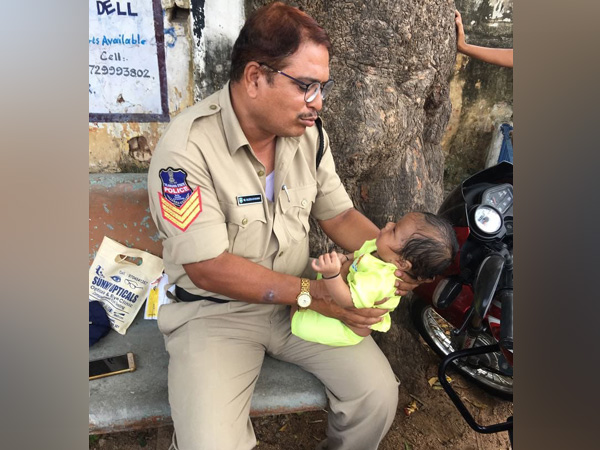Telangana Police takes care of a baby, as infants mother writing her examinations. Telangana Police takes care of a baby, as infants mother writing her examinations.