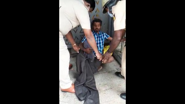 The Assistant Sub-Inspector of Police treating a beggar who is suffering from fever