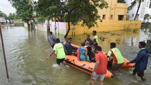 Villagers carrying dead bodies in a river overflowing in Virudhunagar, Tamil Nadu