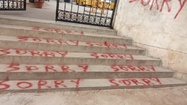 Bengaluru : Boys Writing Sorry Sorry on the Road and Wall of the Shantidhama College 