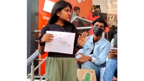 Free hug campaign by a young girl in church street, Bengaluru