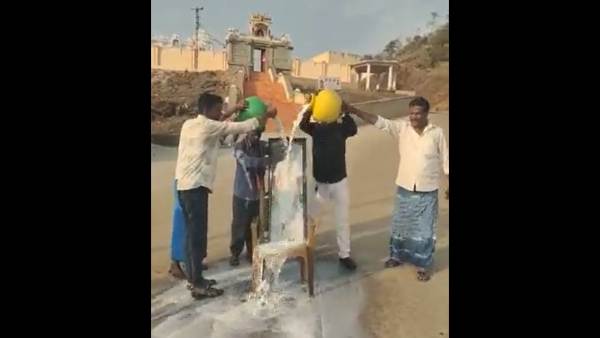 BJP MLA Madal Virupakshappas supporters pour milk on his portrait in front of a temple at Sulekere BJP MLA Madal Virupakshappas supporters pour milk on his portrait in front of a temple at Sulekere