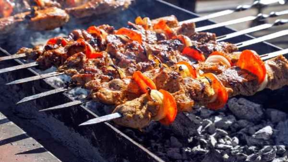 Customer shot Cook over taste of kababs Customer shot Cook over taste of kababs