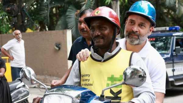 Congress leader Rahul Gandhi rides scooter with a delivery agent