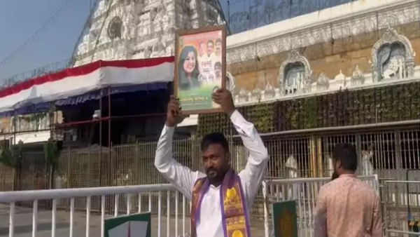 Soumya Reddy campaign in Tirupati Devotee holding Soumya Reddy s photo in front of Tirupati temple Soumya Reddy campaign in Tirupati Devotee holding Soumya Reddy s photo in front of Tirupati temple