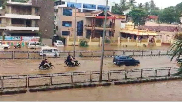 Dharwad Rains Cause Road Flooding Traffic Woes Viral Video of Elderly Man Performing Penance