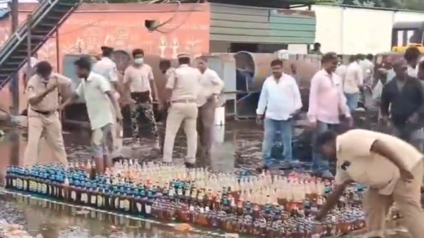 People Carrying Bottles Of Liquor That Were Being Destroyed